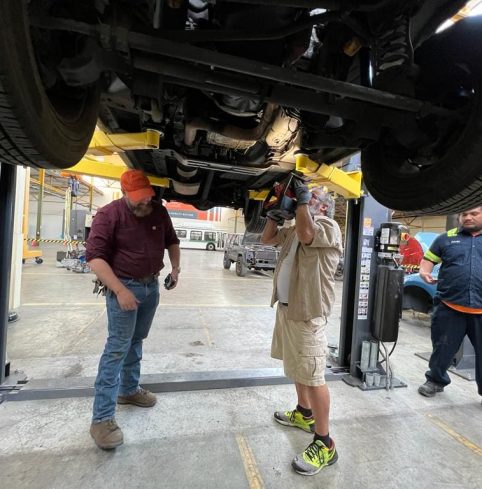 Trainees working on an electric vehicle